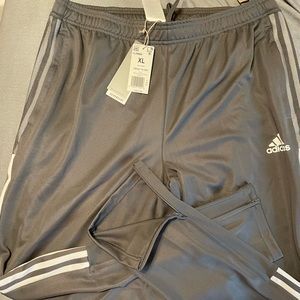 Adidas pants zip up legs. Never worn